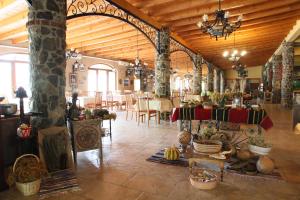 a large room with tables and chairs in a building at Hotel Tutto in Galičnik