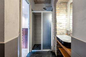 a bathroom with a walk in shower and a sink at Il Giardino Dell'Argano Rosso in Rome