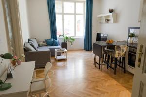 a living room with a couch and a table at Oltec Apartment Brno in Brno