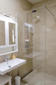 a bathroom with a sink and a glass shower at Oltec Apartment Brno in Brno