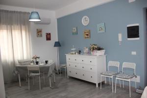 a room with a table and chairs and a dresser at Dimora Fraula Guest House in Agrigento