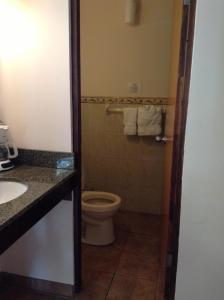 a bathroom with a toilet and a sink at Luquillo Sunrise Beach Inn in Luquillo