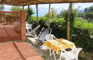 a patio with a table and chairs on a deck at Residence Capobianco in Portoferraio