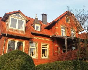 an orange house with a red roof at Reinecke Fuchs in Bad Münder am Deister