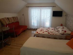 a living room with two beds and a couch at Apartmány BOSS in Liptovský Mikuláš