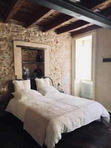 1 dormitorio con 1 cama grande en una pared de piedra en Olivia Suite Charme&Relax, en Bérgamo