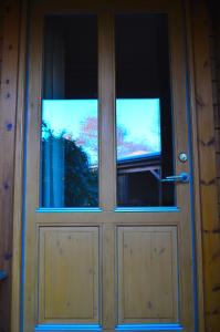 a wooden door with two windows on it at Holmgård in Süderholm