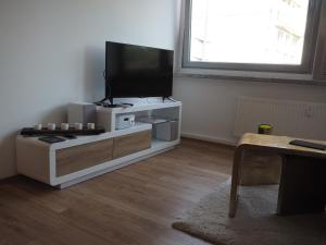 a living room with a flat screen tv on a entertainment center at 41 Reichsstraße in Düsseldorf