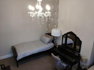 a bedroom with a bed and a mirror and a piano at Lion House Bed & Breakfast with Restaurant in Combe Martin