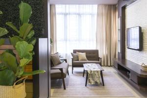 a living room with a couch and a table at Arc1901 staycation in Kota Bharu