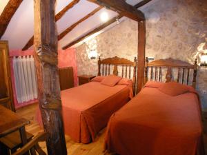 a bedroom with two beds in a room at La Posada de Carmen in Chañe +10 photos