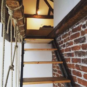 a staircase in a room with a brick wall at Pop Bogomil family hotel in Sofia