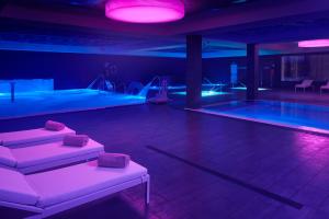 a room with a swimming pool and purple lighting at Hotel & Thalasso Villa Antilla - Habitaciones con Terraza - Thalasso incluida in Orio