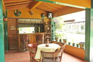 a restaurant with a table and chairs in a room at Hotel Agua Blanca in San José Purúa