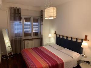a bedroom with a bed with a colorful striped blanket at Residence Sole in Trieste