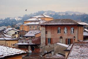 a group of buildings with snowcovered roofs at Mambo Suites in Bologna