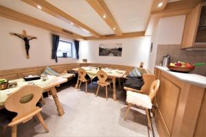 a kitchen and dining room with wooden tables and chairs at Gästehaus Sonner in Dietmannsried
