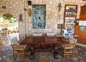 a wooden table and chairs in a room at Irides in Souvala