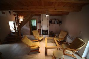 a living room with several chairs and a table at Bieszczadzki Kąt in Lesko