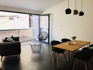 a living room with a table and chairs and a couch at Casa Geayh in Marseillan