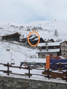 an orange circle on top of a building in the snow at Casetta Chamois in Chamois