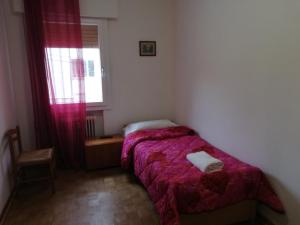 a small bedroom with a bed and a window at Venice Holiday in Marghera