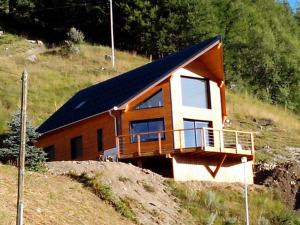 a small house with a balcony on a hill at CHALET TRIPTYQUE in Orcières