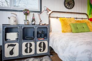 a bed with a blue cabinet with numbers on it at Skipbridge Farm Glamping in Green Hammerton