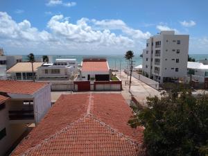 a view of the ocean from the roofs of buildings at Praia de Camboinha-PB apto bacana! in Cabedelo