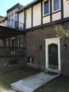 a brick building with a door and a balcony at Mill Stone - Mt Penn Lodging in Mount Penn