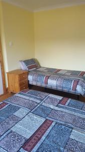 a bedroom with two beds and a wooden dresser at Tomedjocon in Fermoy
