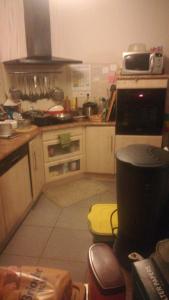 a kitchen with a stove top oven in a kitchen at maison la croix chambre chez l ' habitant in Marsac