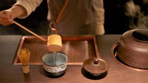 a person stirring a bowl with a wooden spoon at THE THOUSAND KYOTO in Kyoto +88 photos