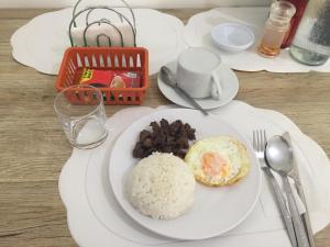 a plate of food with rice and beans on a table at 4C's Tourist Lodge in Puerto Princesa City