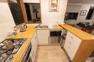 a kitchen with a sink and a stove top oven at Wedgetail in Dinner Plain
