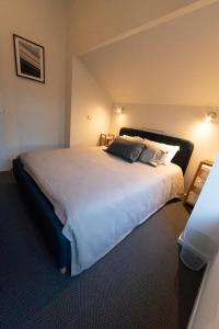 a bedroom with a large white bed in a room at Wedgetail in Dinner Plain