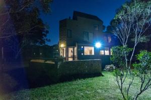 a house with a light on the side of it at night at Wedgetail in Dinner Plain