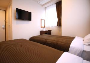 Postel nebo postele na pokoji v ubytování Hotel Trend Tobu Asakusa-Eki Kita