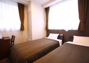 Säng eller sängar i ett rum på Hotel Trend Tobu Asakusa-Eki Kita