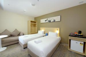 Postel nebo postele na pokoji v ubytování ibis Budget - Melbourne CBD