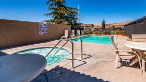 a swimming pool with a pool table and chairs at SureStay Hotel by Best Western Tehachapi in Tehachapi