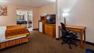 a hotel room with a bed and a desk with a computer at SureStay Hotel by Best Western Tehachapi in Tehachapi