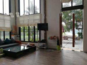 a living room with a couch and a tv at Baantidnam in Ban Thung Tho +69 photos