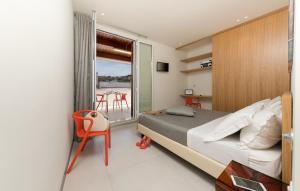 a bedroom with a bed and a balcony with a table at B&B Adduari in San Vito lo Capo