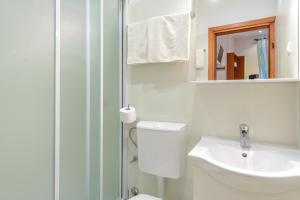 a bathroom with a toilet and a sink and a shower at Studio Apartments Stradun in Dubrovnik