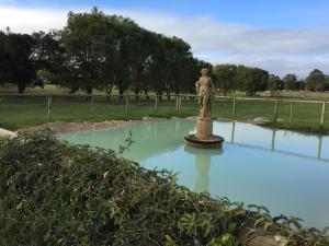 a statue of a woman standing in a pool of water at Manjimup Gateway Hotel in Manjimup