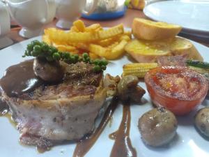 a plate of food with meat and french fries at Friendly Koh Jum in Ko Jum