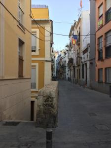 une rue vide dans une ruelle avec des bâtiments dans l'établissement Piso moderno en casco antiguo próximo a la playa, à Alicante 3 autres photos