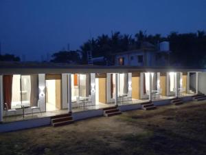 a building with a lot of windows at night at Cassiopeia Nest in Arambol