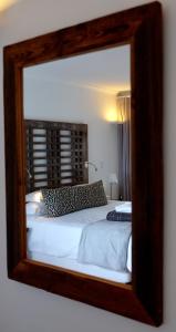 A bed or beds in a room at Agulhas Ocean House 